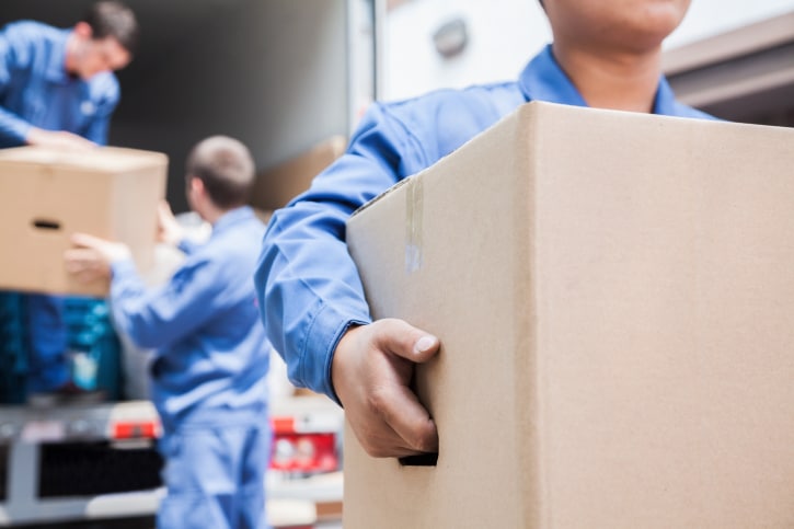 Men unloading boxes from moving van