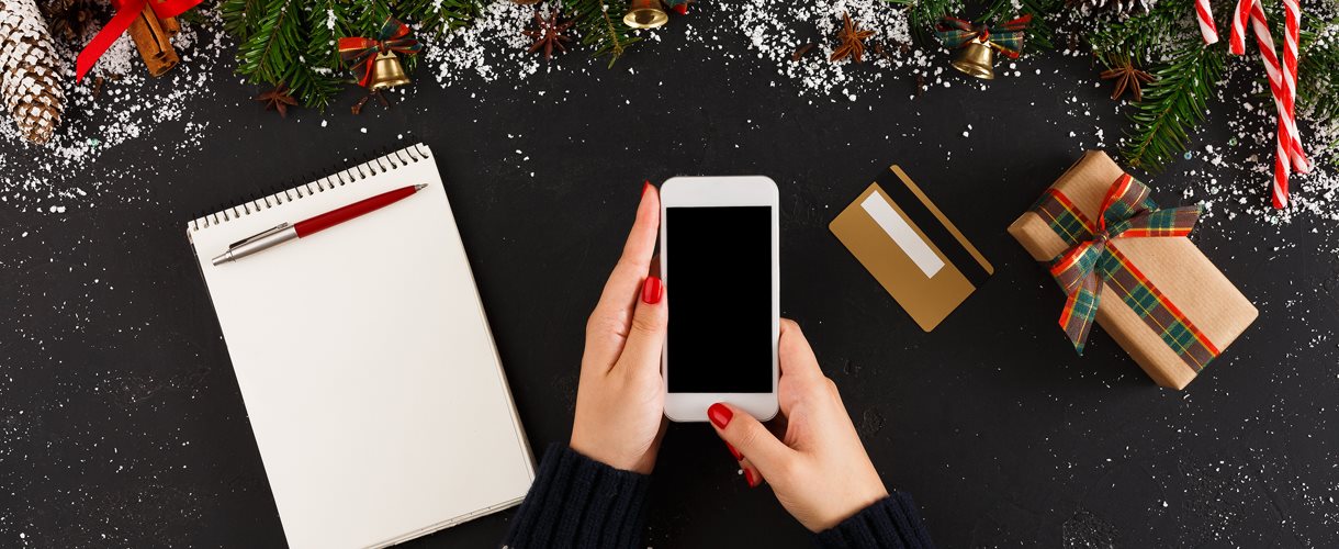 Mobile phone, credit card, notepad and christmas present