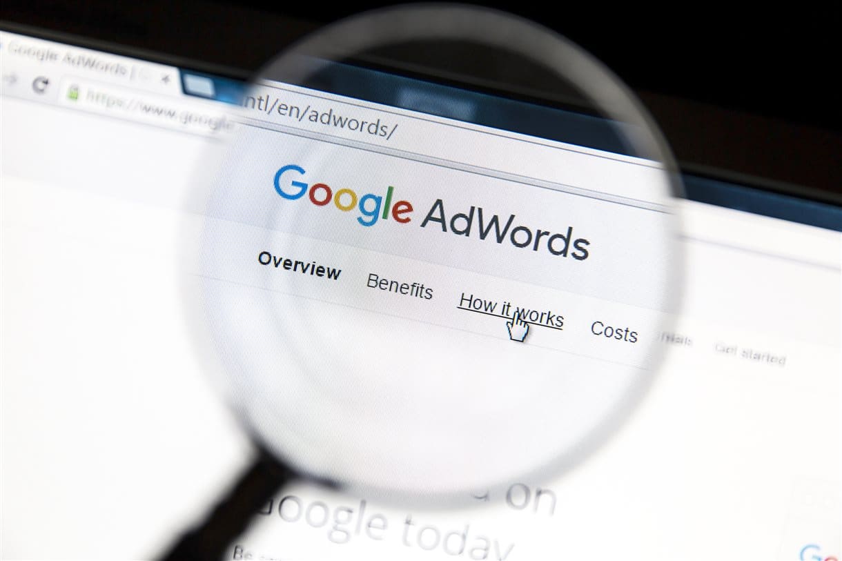 Magnifying glass over Google AdWords logo