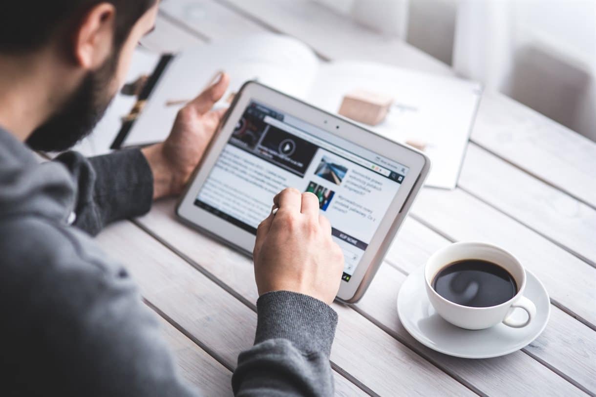 Man reading an article on tablet