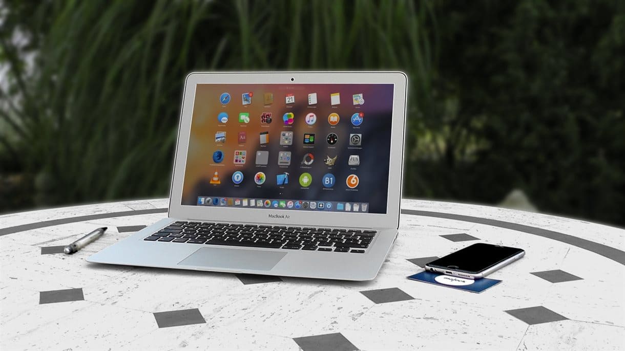 Macbook on table with various icons