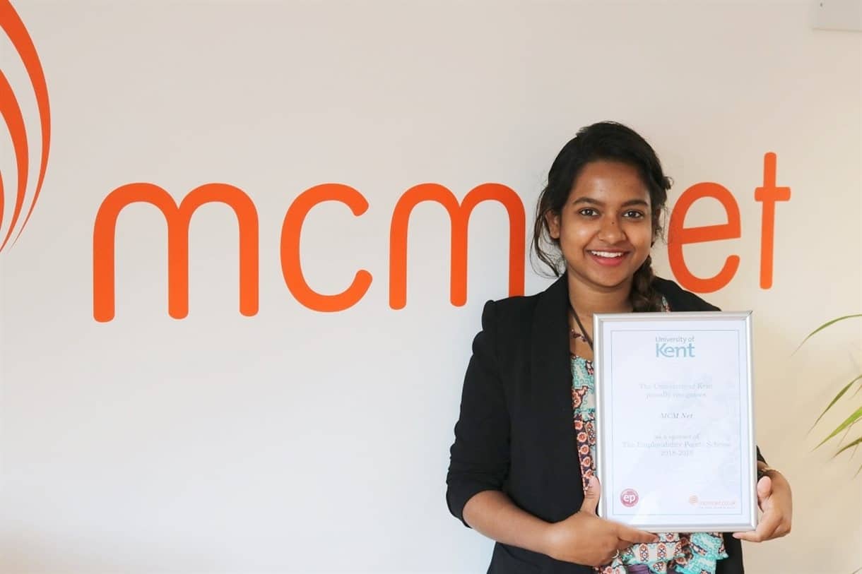 MCM intern holding certificate of sponsorship
