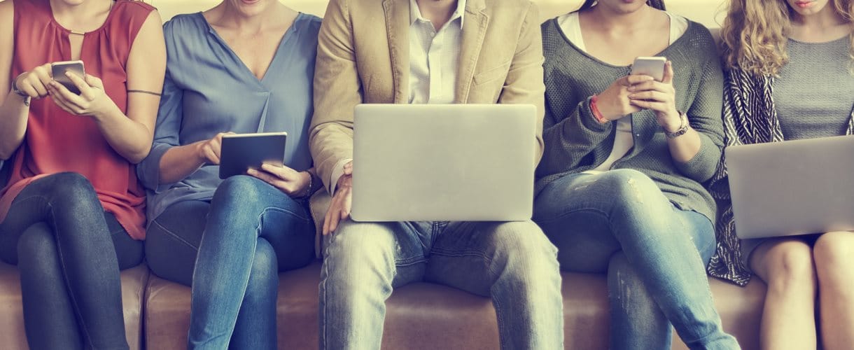 Row of people using electronic mobile devices