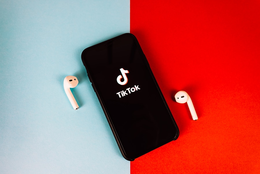 Phone with Tiktok logo and airbuds