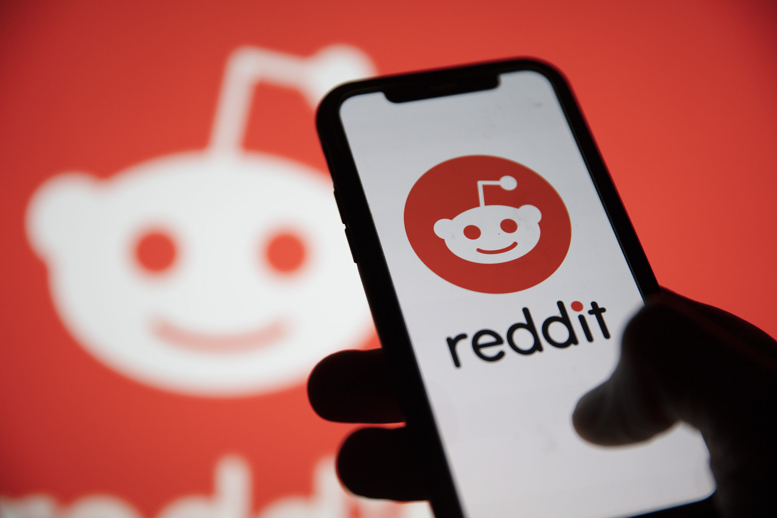 Reddit logo on phone screen