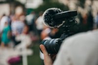 Person holding a camera videoing an event